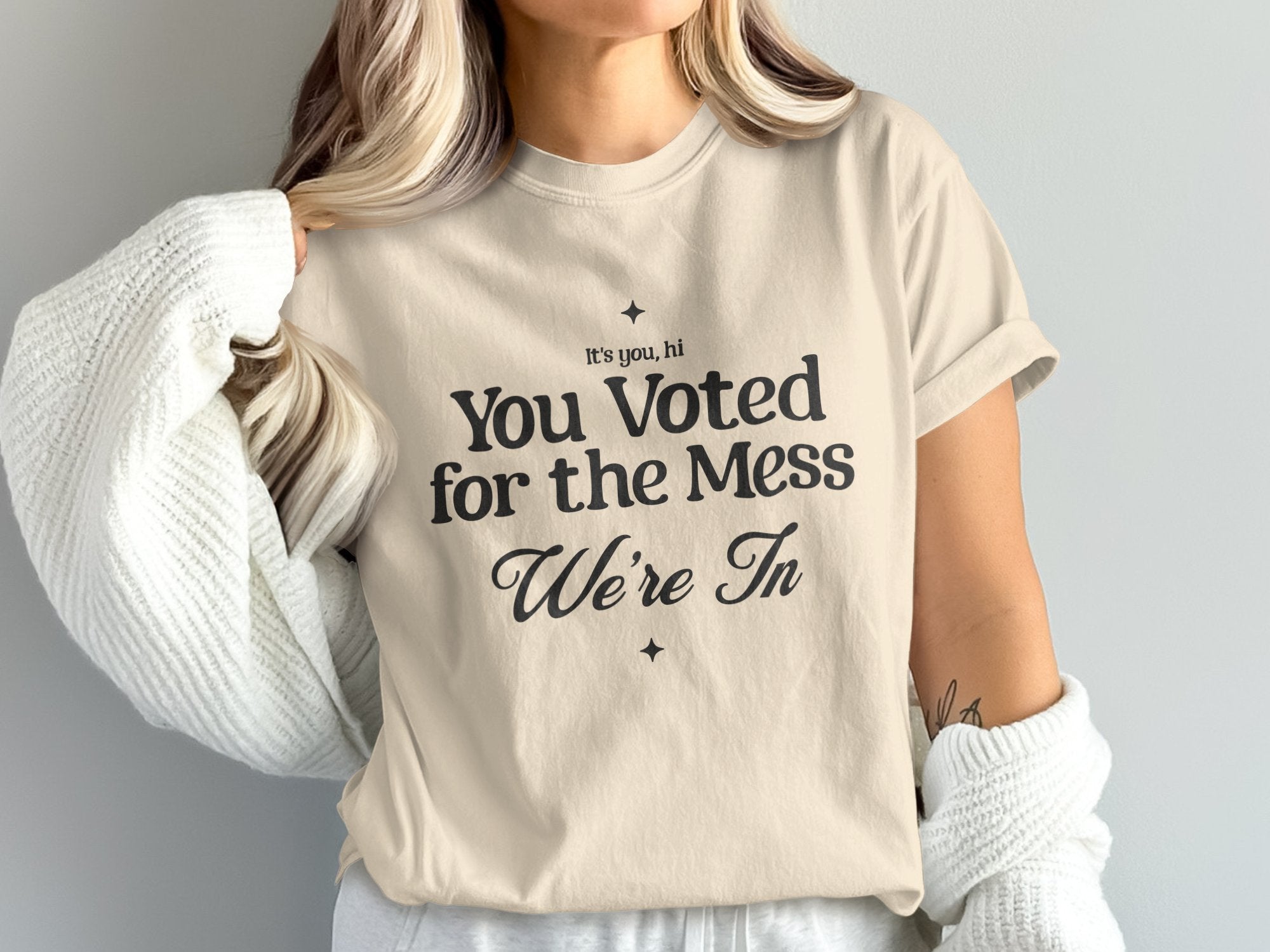 a woman wearing a t - shirt that says you voted for the mess we