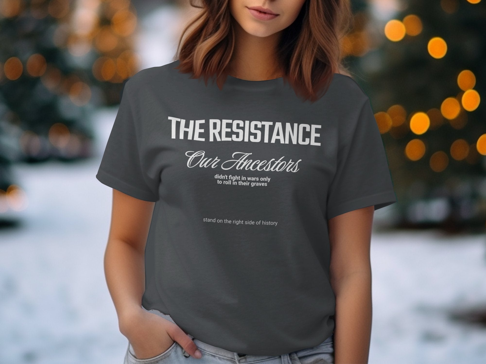 a woman wearing a t - shirt with the words the resistance on it