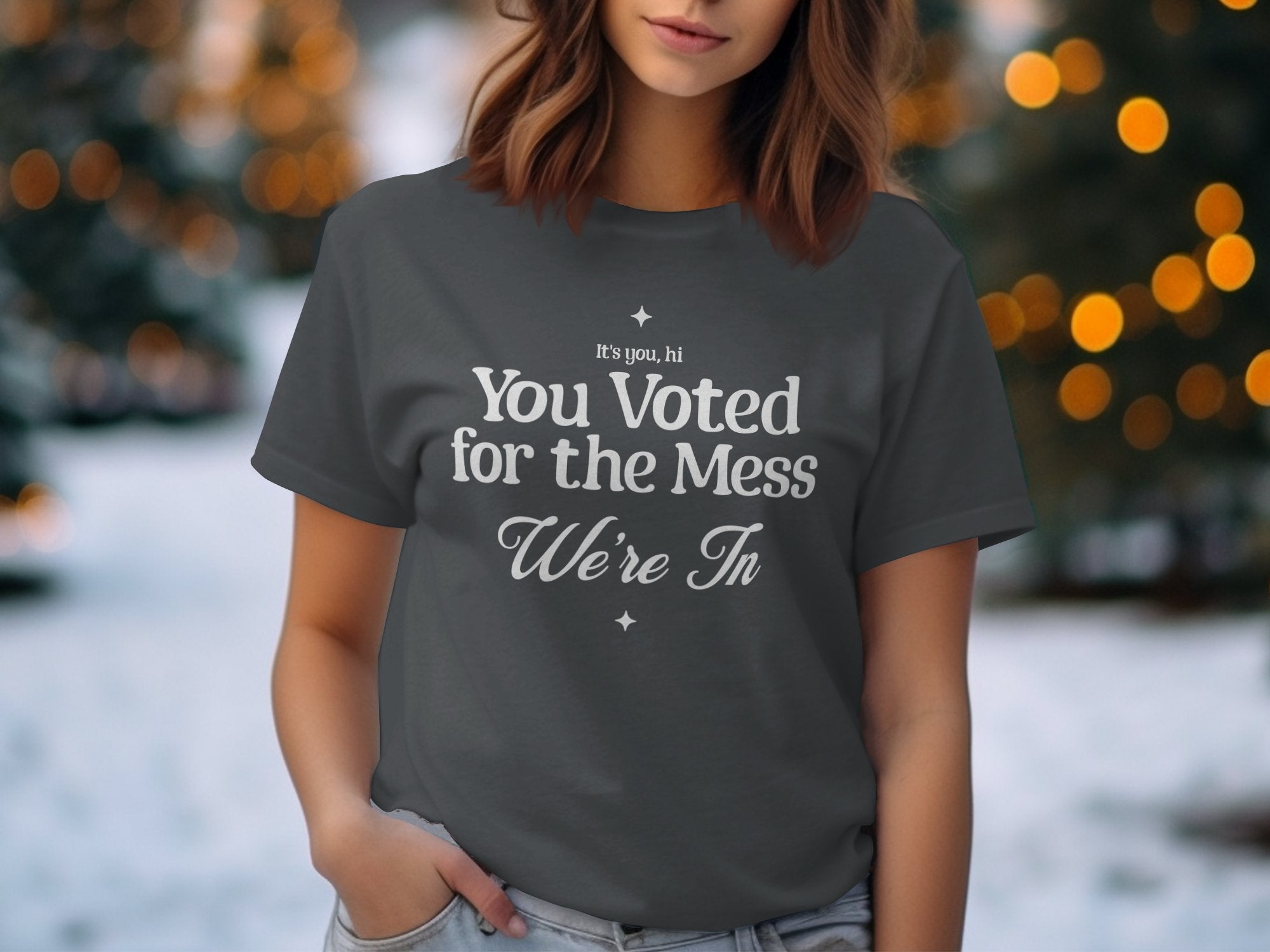 a woman wearing a t - shirt that says you vote for the mess we '