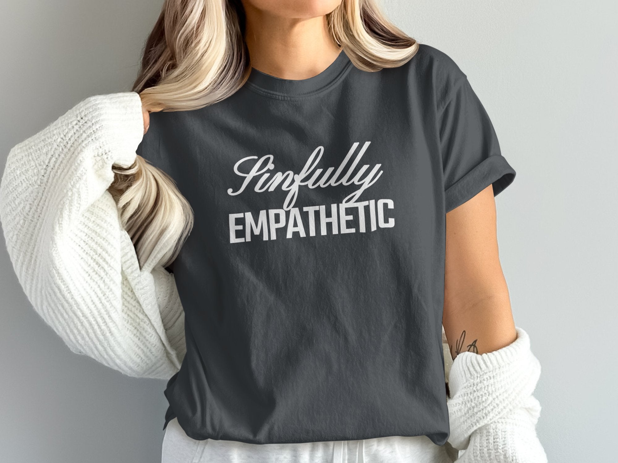 a woman wearing a t - shirt that says impfully empathetic