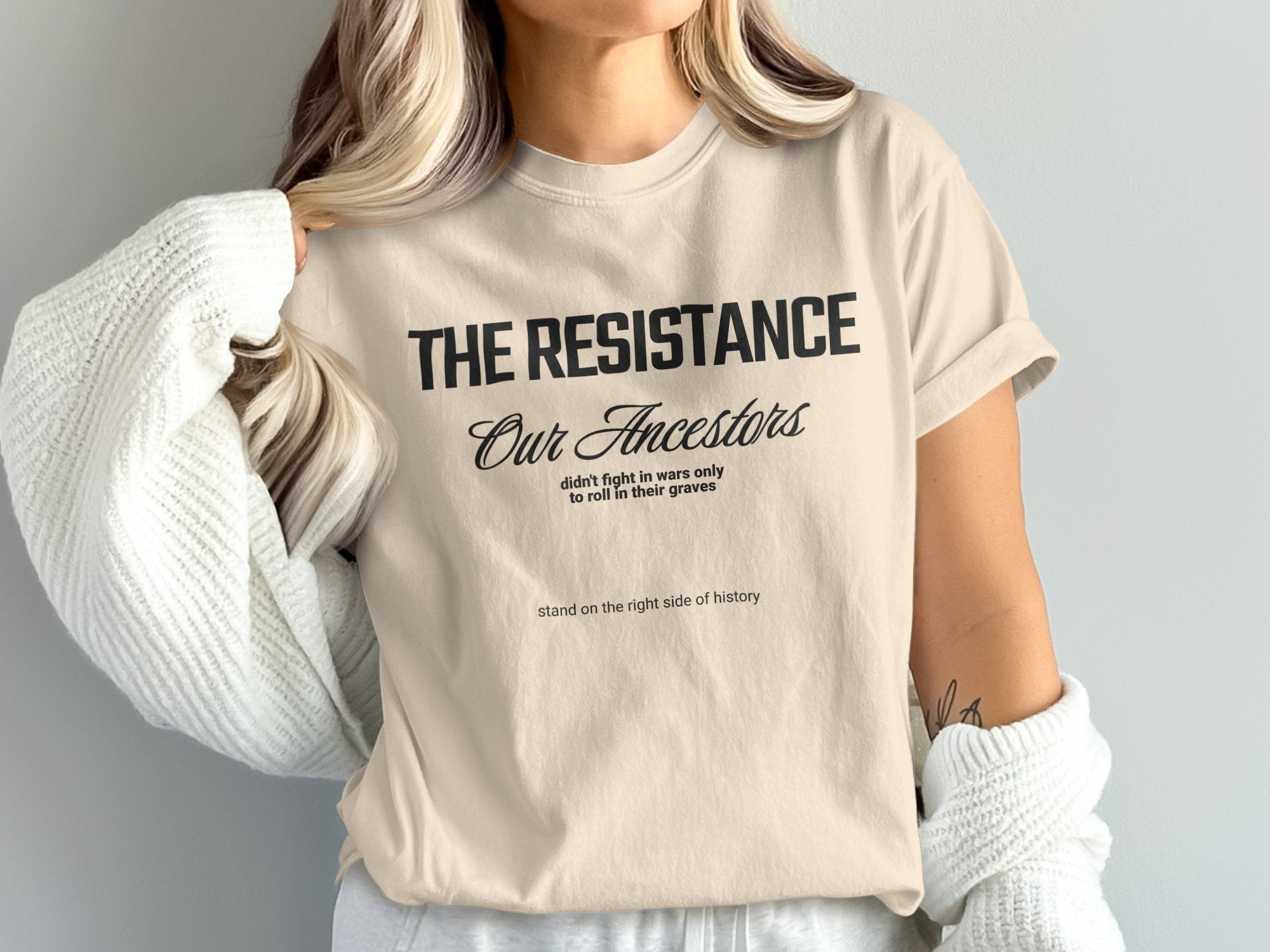 a woman wearing a t - shirt with the words the resistance on it