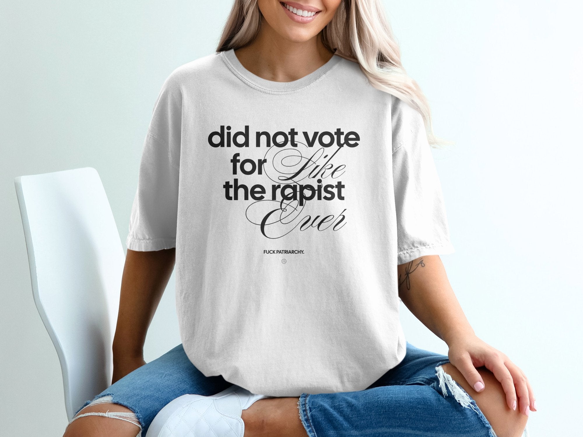 a woman sitting on a chair wearing a t - shirt that says did not vote