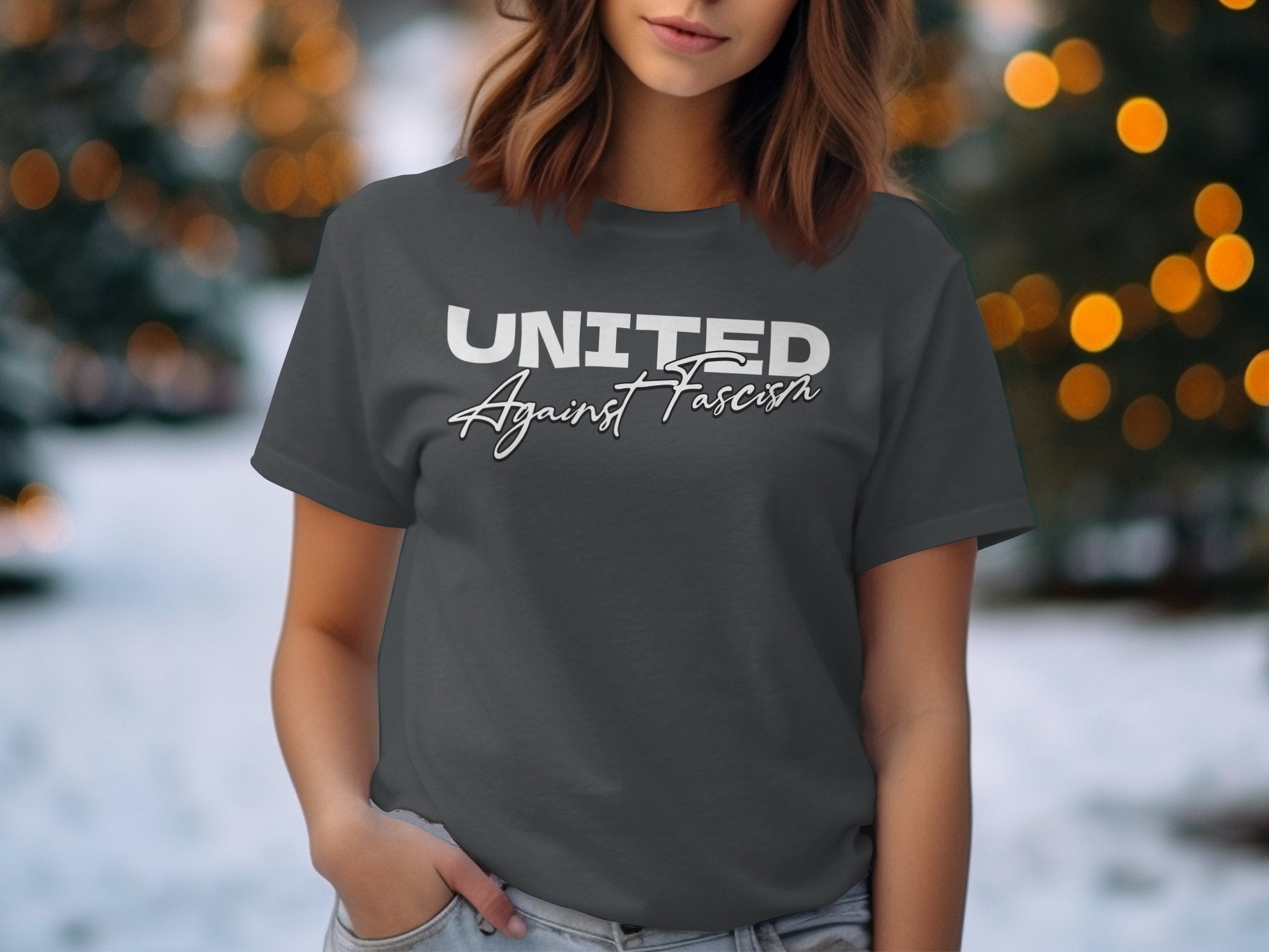 a woman wearing a united apparel t - shirt in the snow