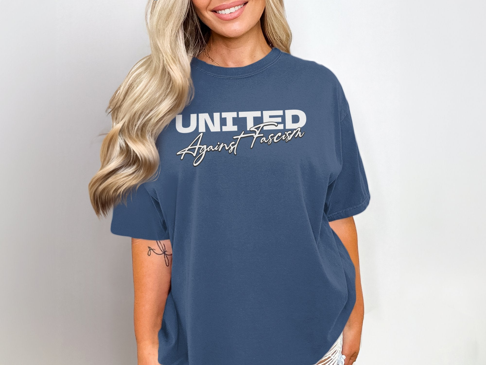 a woman wearing a blue united t - shirt